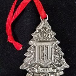 A Christmas shaped medal with a ribbon