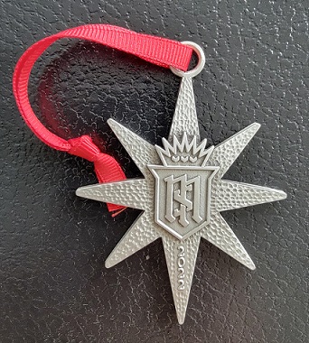 A star shaped medal with a red ribbon