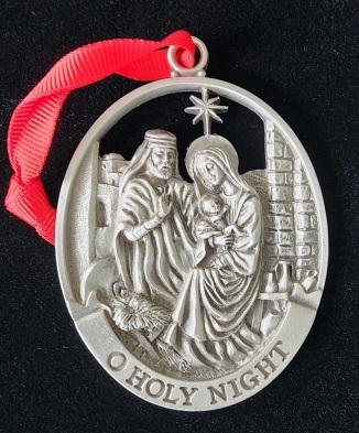 Pewter ornament depicting the nativity scene.