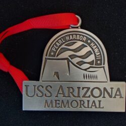 A metal USS Arizona Memorial ornament.