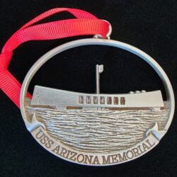 A metal USS Arizona Memorial ornament.