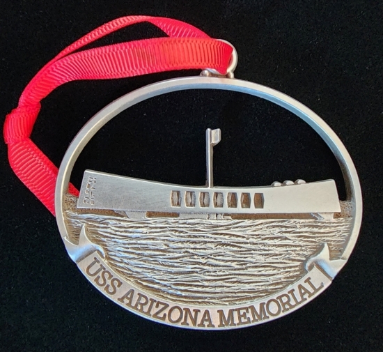 A metal USS Arizona Memorial ornament.