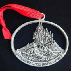 A silver ornament with a picture of mount hood.