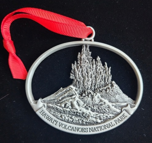 A silver ornament with a picture of mount hood.